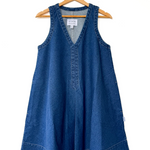 Blue denim dress on a hanger against a white background
