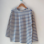 Blue and white striped shirt on a wooden hanger against a white background