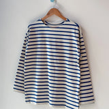 Blue and white striped shirt on a wooden hanger against a white background