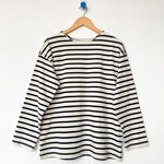 Navy and white striped shirt on a hanger against a white background