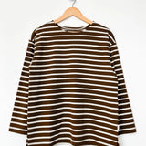 Brown and white striped shirt on a hanger against a white background