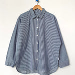 Blue striped shirt on a wooden hanger against a white background