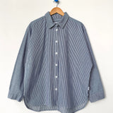 Blue striped shirt on a wooden hanger against a white background