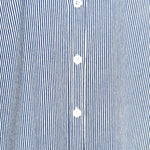Close-up of a blue and white striped shirt with buttons.