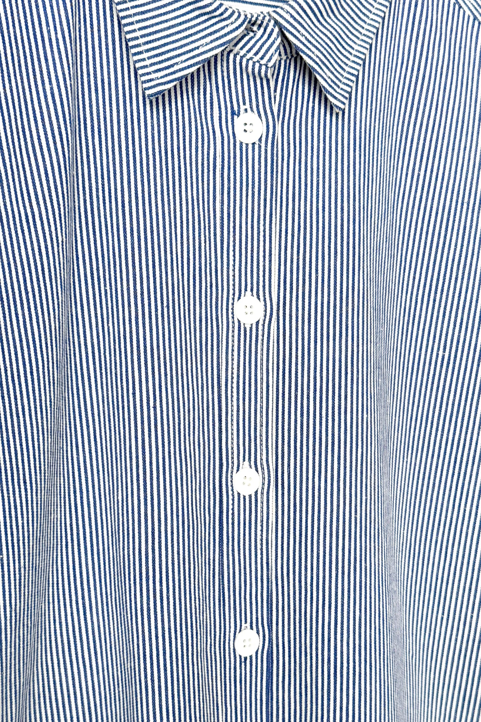 Close-up of a blue and white striped shirt with buttons.