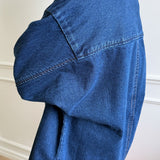 Back of person wearing a dark denim shirt and red pants