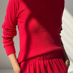 Person wearing a red outfit with a plain background