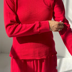 Person wearing a red outfit with a plain background