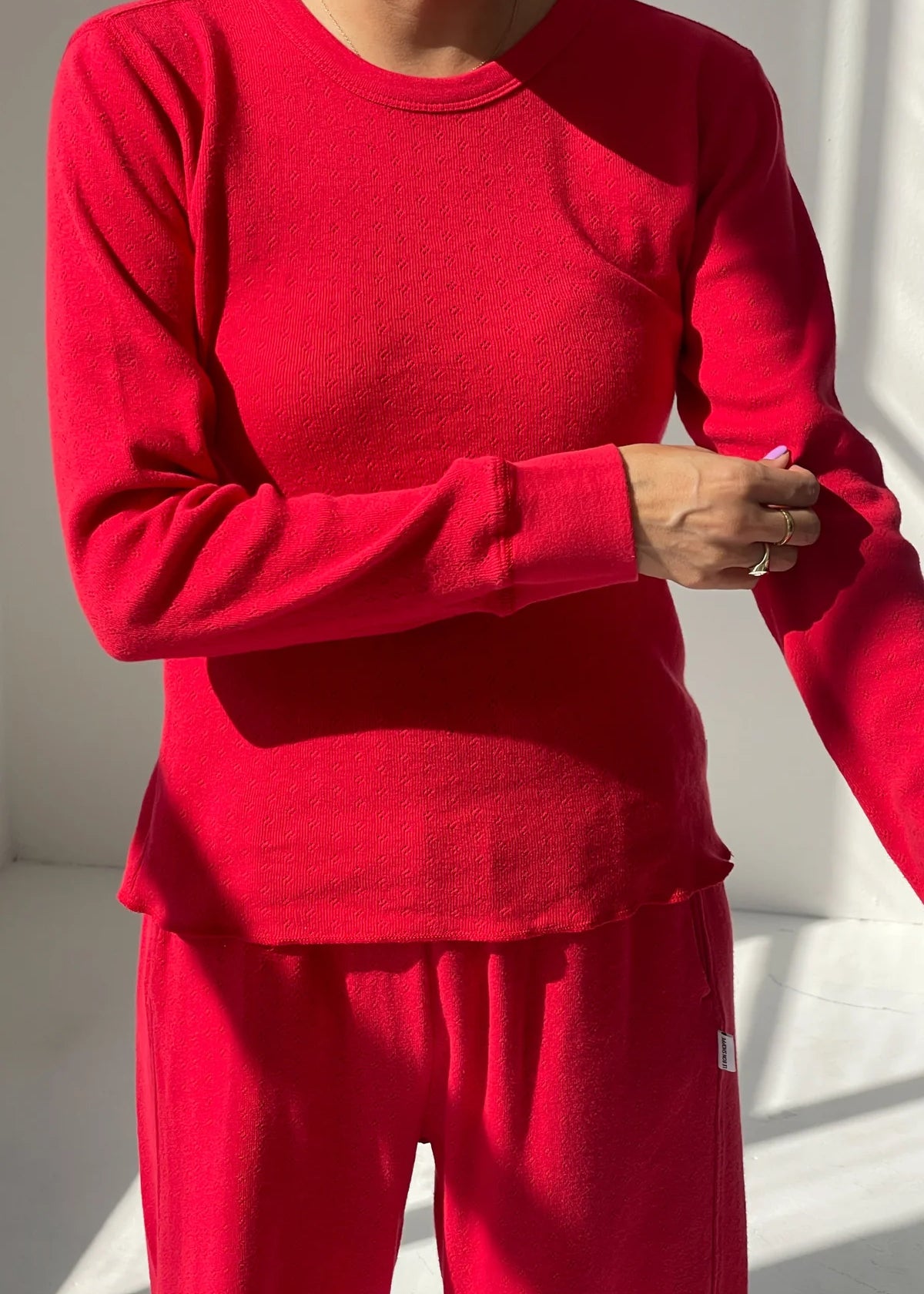 Person wearing a red outfit with a plain background