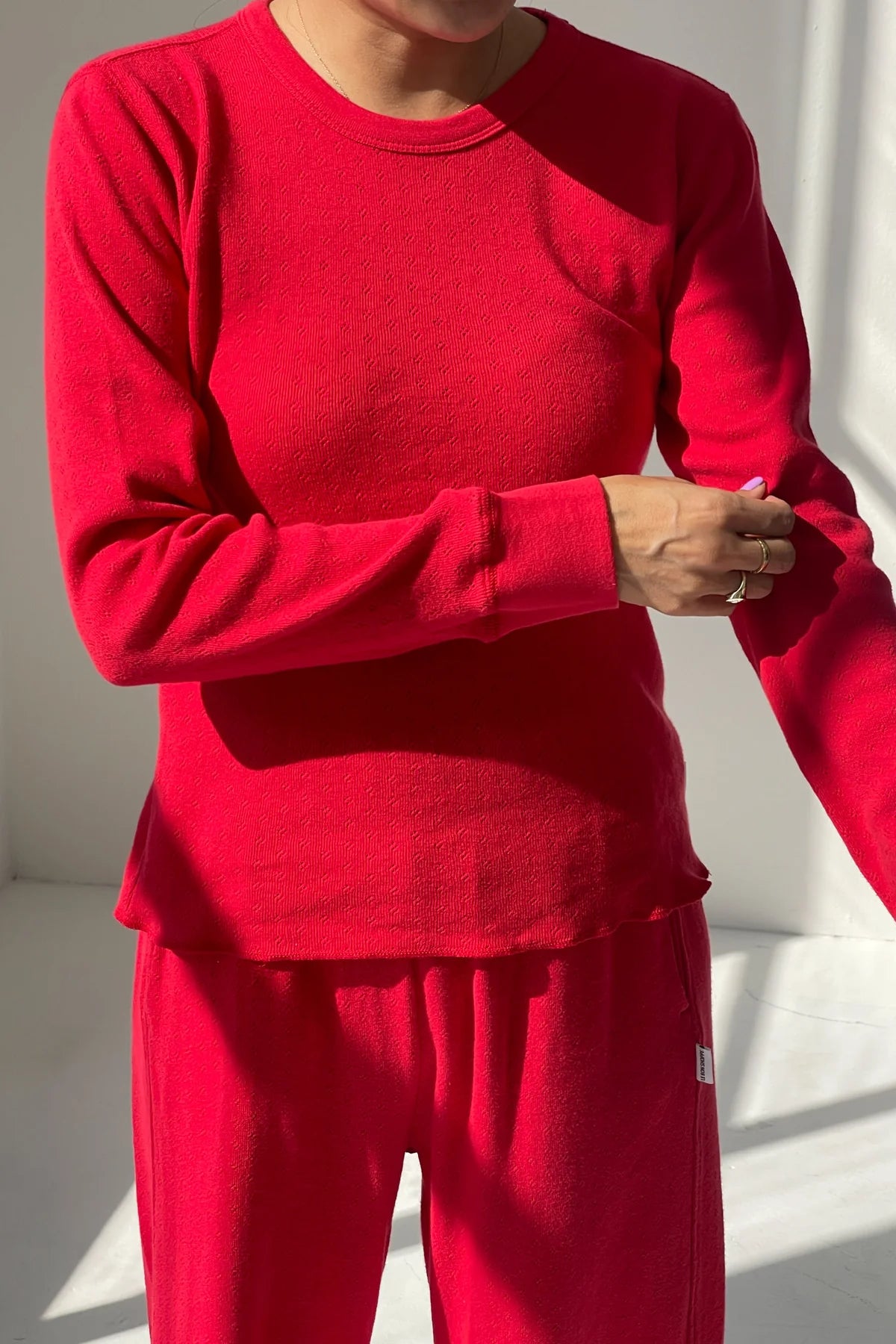 Person wearing a red outfit with a plain background