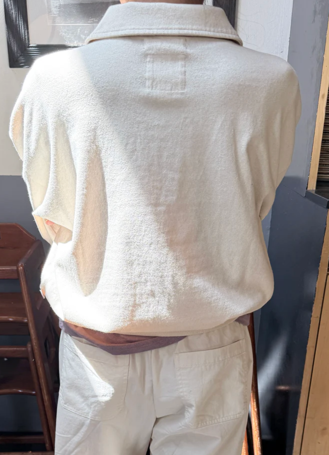 Beige short-sleeve shirt and pants on a mannequin against a neutral background
