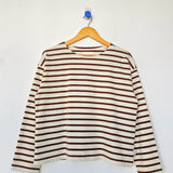 Striped long-sleeve shirt on a hanger against a white background