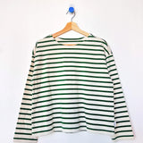 Green and white striped shirt on a hanger against a white background