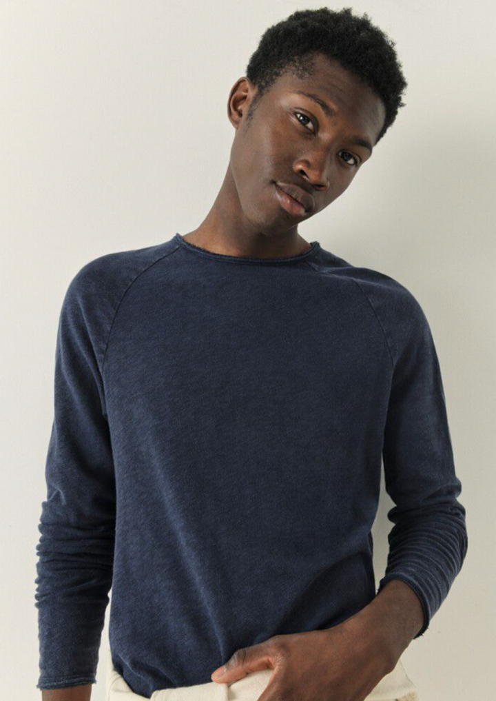 A medium close image showing a male model wearing the Sonoma Long Sleeve in vintage navy