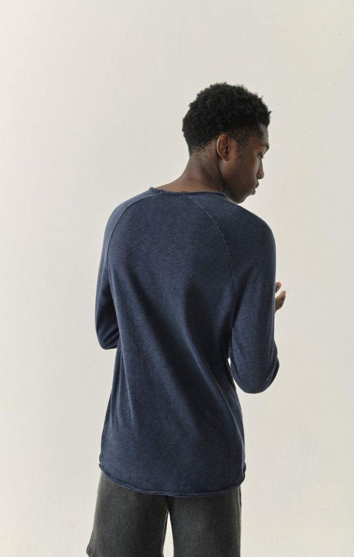 A half body image showing the back side of a male model wearing the Sonoma Long Sleeve in vintage navy