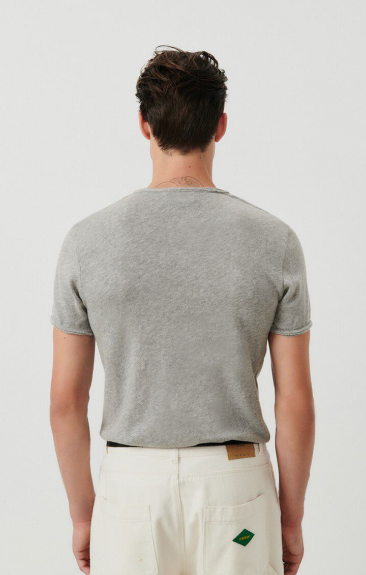 A medium close image of the backside of a male model wearing the Sonoma tee shirt in grey. 