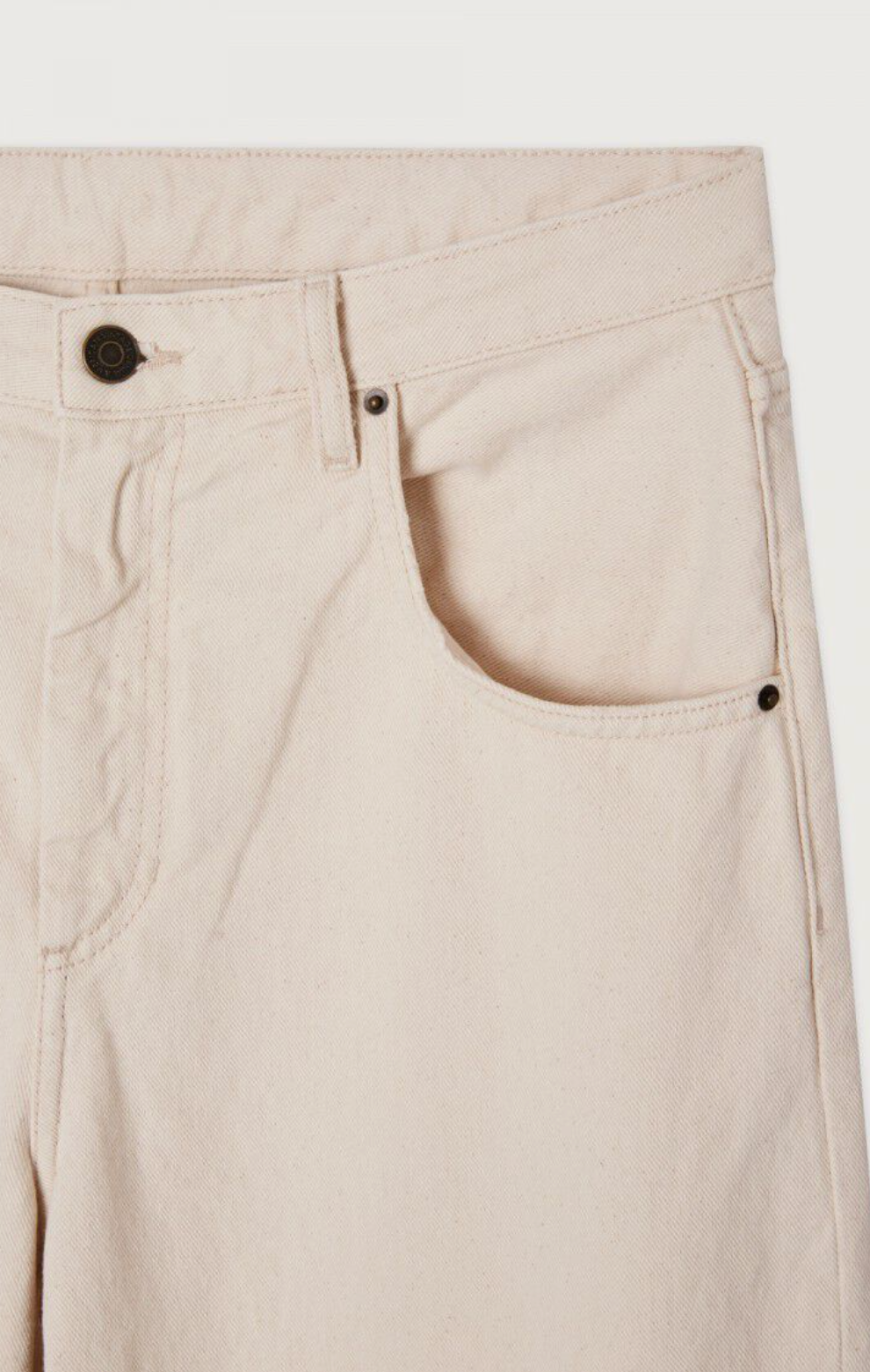 A close up detail flat lay image showing the waistline and front pocket