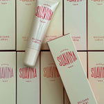 Suavina lip balm packaging with a tube and boxes on a matching background