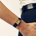 Breda Virgil Lizard watch with black embossed leather strap and gold dial on wrist