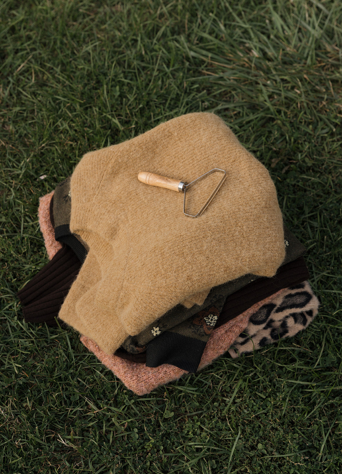 Beige helmet with a tool on grass