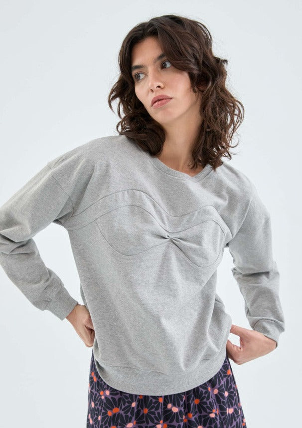 A medium close up, upper body image of a female model posing in the Sweatshirt with seam detail