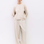 Person wearing a beige outfit on a white background