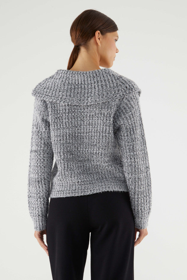 A medium close image of the backside of a model wearing the Collar Lace-Up Sweater