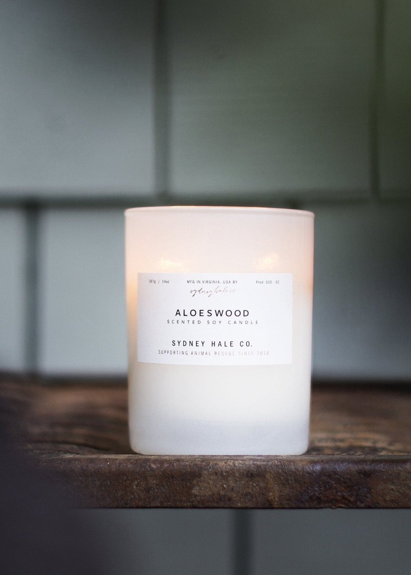 Candle in a frosted cream glass vessel