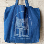 A denim tote with a sketch of the Frances Jaye store front on it.