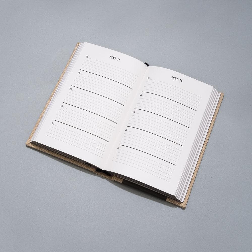 One Line a Day journal laying on grey background.