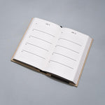 One Line a Day journal laying on grey background.