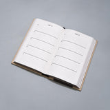 One Line a Day journal laying on grey background.