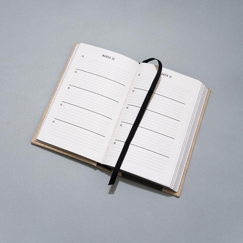 One Line a Day journal laying on grey background.