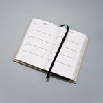One Line a Day journal laying on grey background.