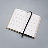 One Line a Day journal laying on grey background.