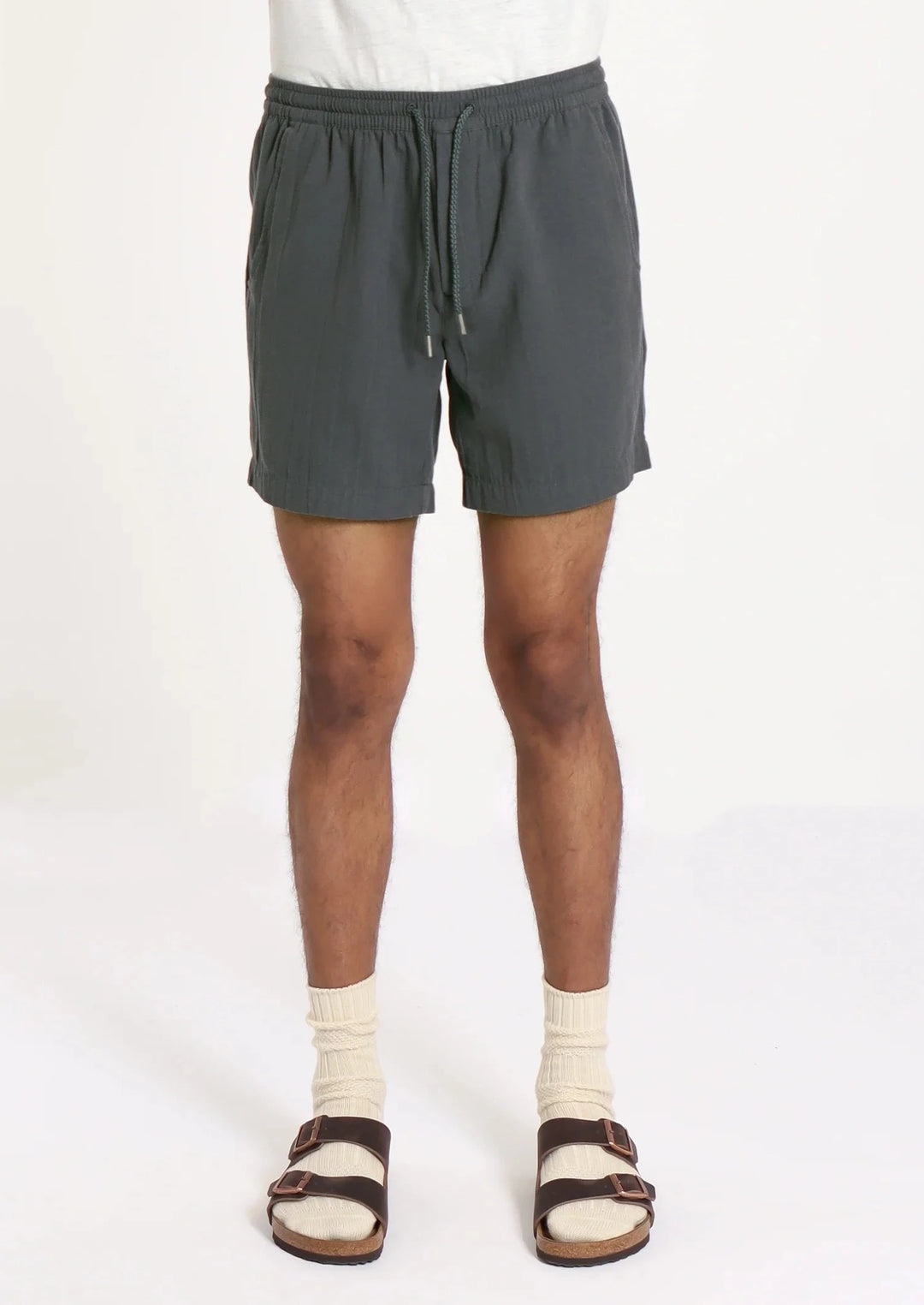 Navy seersucker shorts on man wearing socks and birkenstocks