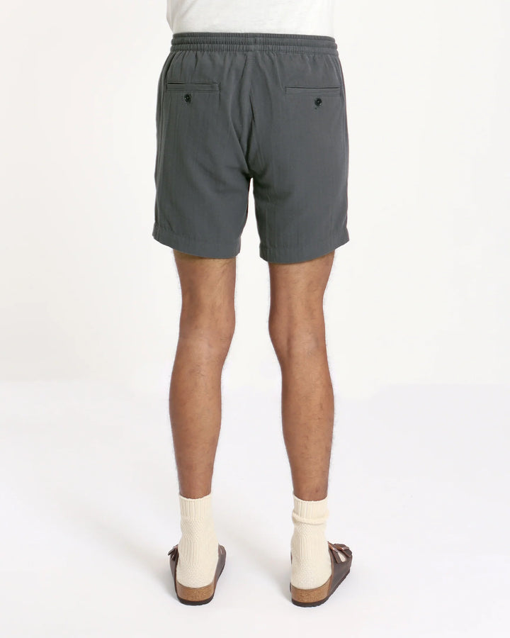 Navy seersucker shorts on man wearing socks and birkenstocks