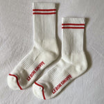 White socks with red stripes laying on white background