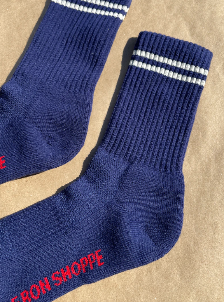 Navy socks with white stripes on a kraft paper background.