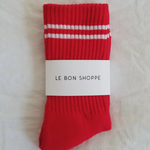 Red socks with white stripes in Le Bon Shoppe packaging.