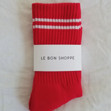 Red socks with white stripes in Le Bon Shoppe packaging.
