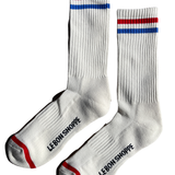 White socks with red and blue stripe and Le Bon Shoppe branding on white background