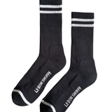 Black socks with white stripes and Le Bon Shoppe branding on white background
