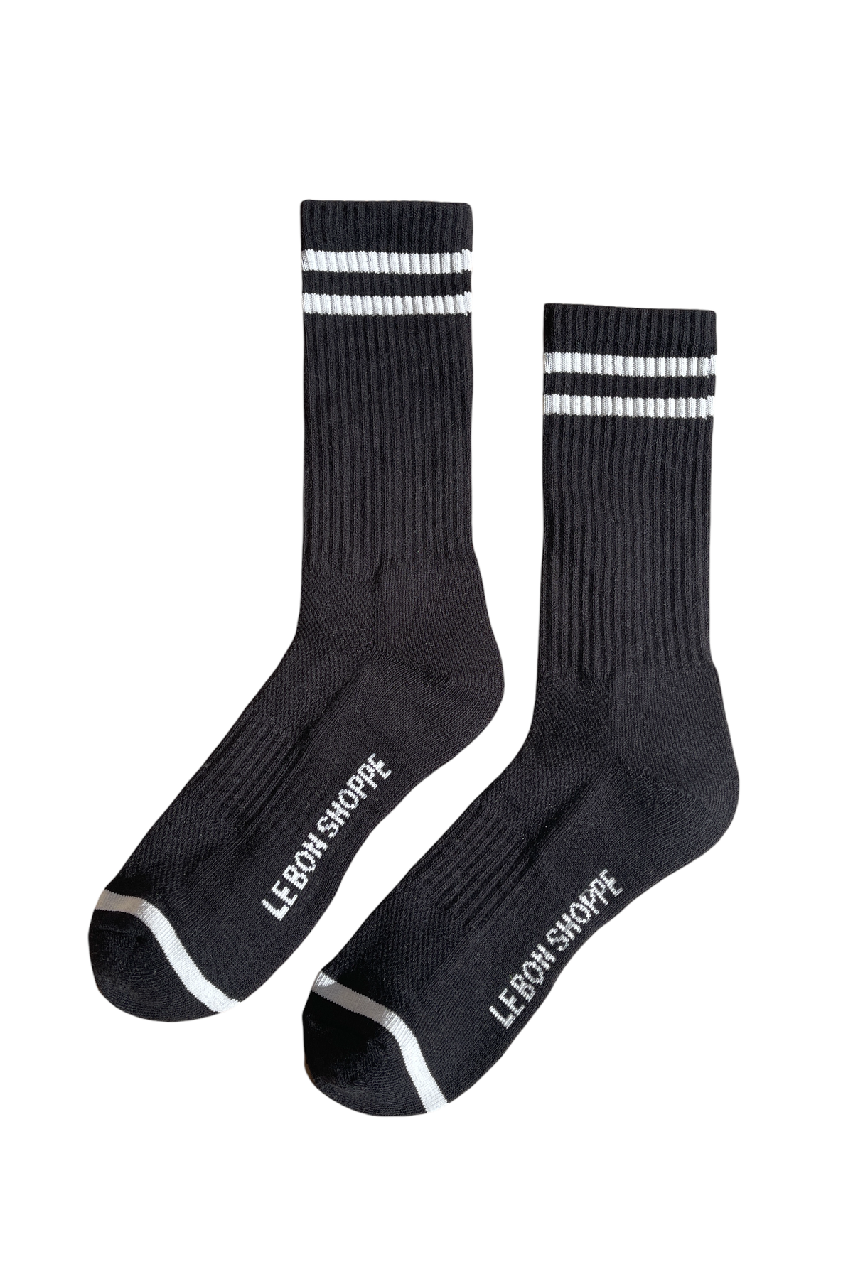 Black socks with white stripes and Le Bon Shoppe branding on white background