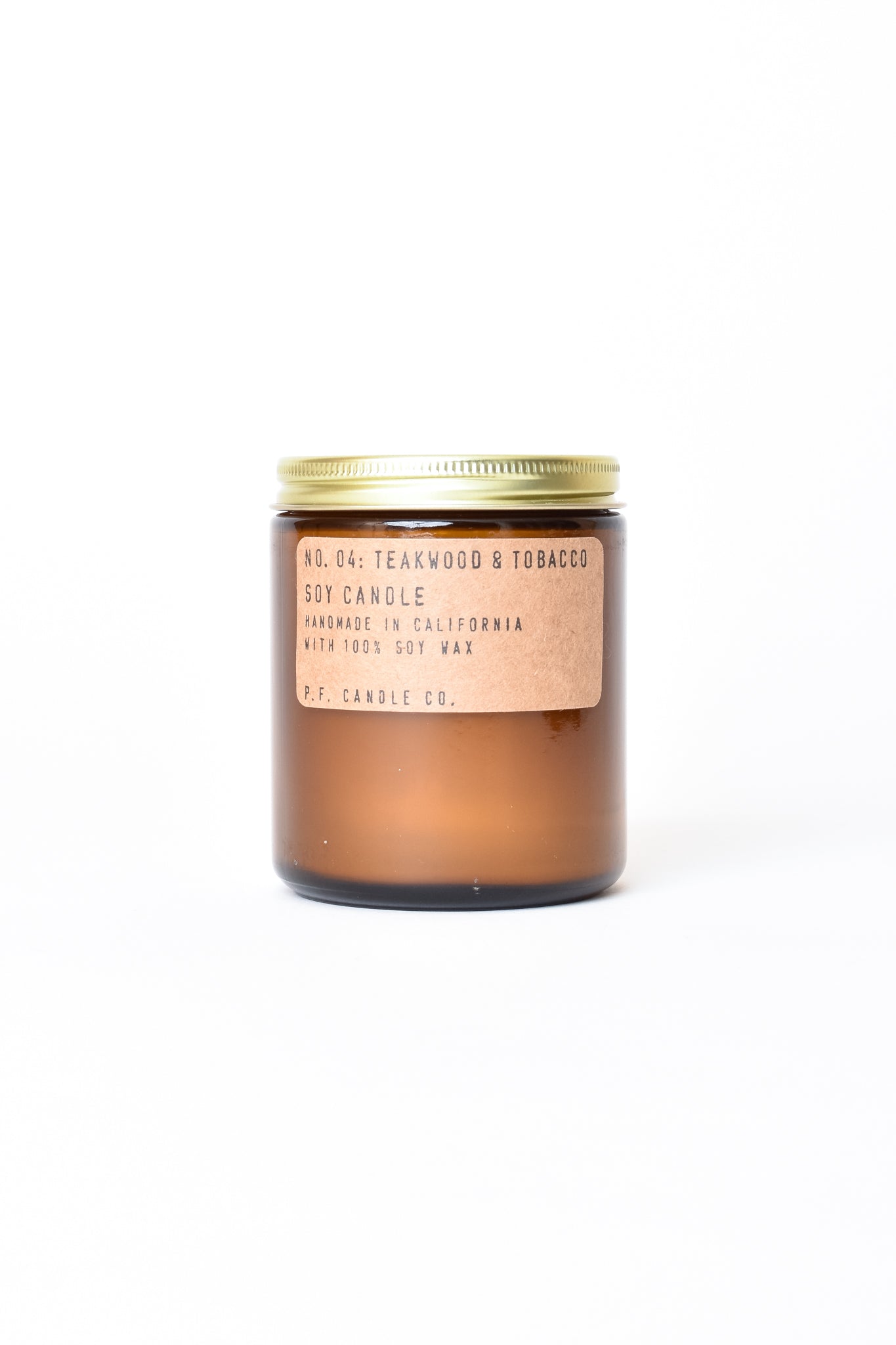 Candle in amber glass vessel
