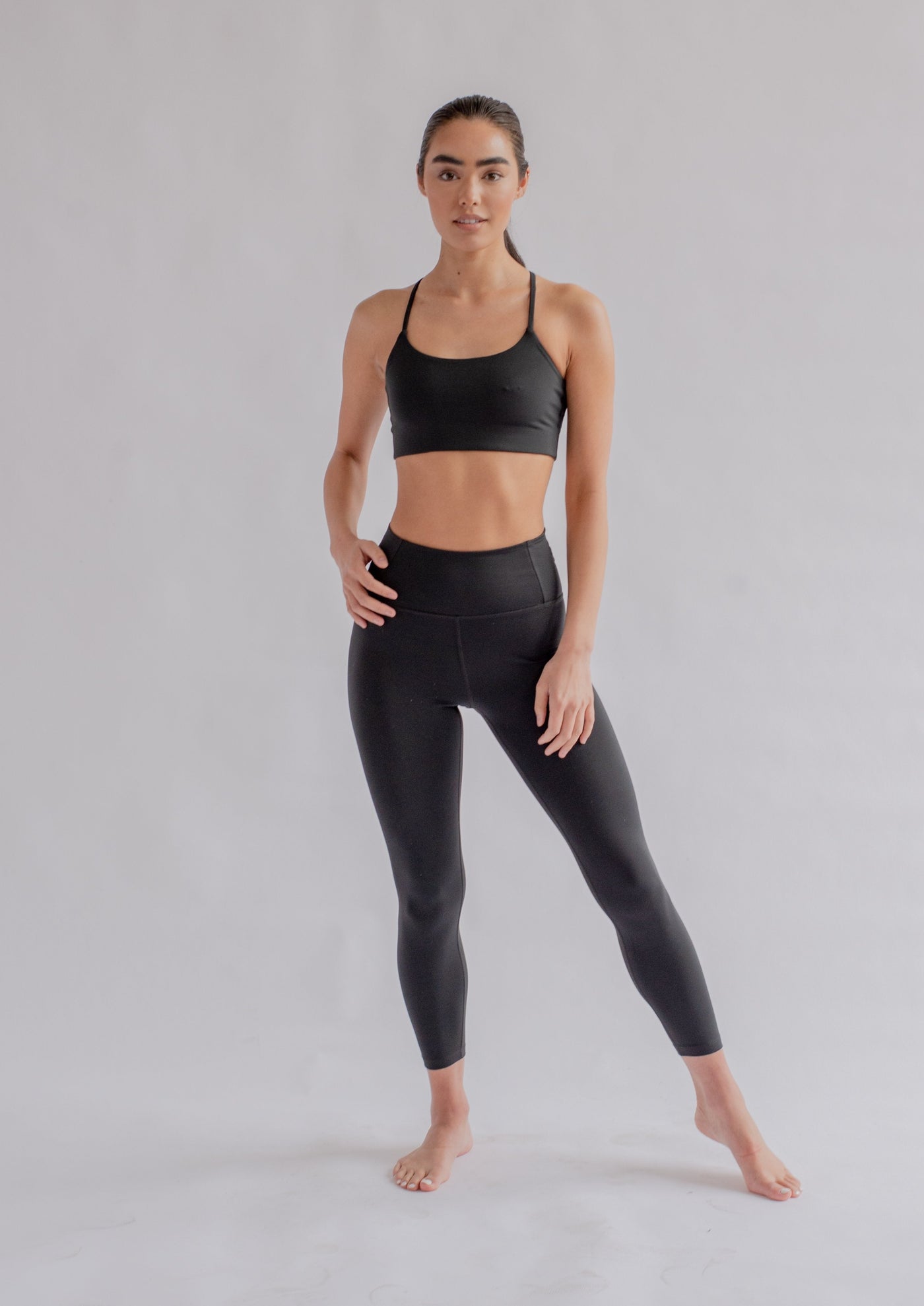 Woman in black leggings and sports bra