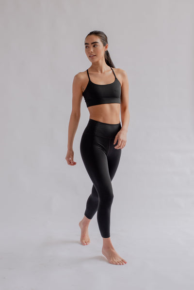 Woman in black leggings and sports bra