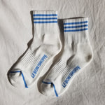 White socks with blue stripes and Le Bon Shoppe branding on white background
