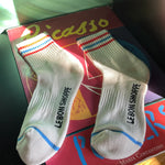 White socks with red and blue stripes laying on Picasso poster