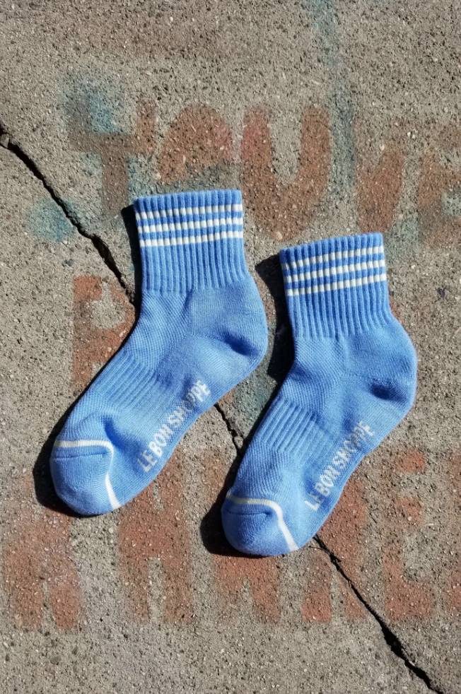 Blue socks with white stripes on a concrete background
